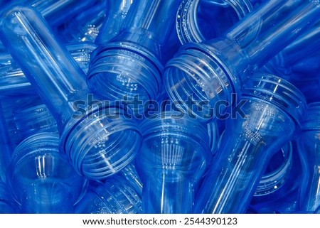Close up scene of group of preform shape of PET bottle products. The raw material for plastic bottle manufacturing process.
