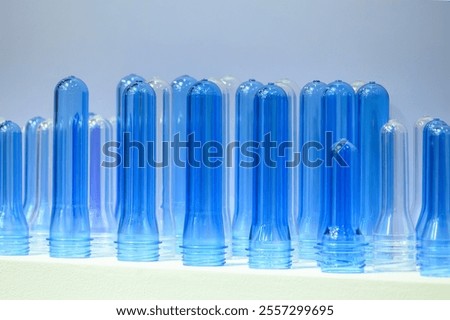 Close up scene of group of preform shape of PET bottle products. The raw material for plastic bottle manufacturing process.