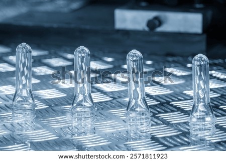 Close up scene of group of preform shape of PET bottle products. The raw material for plastic bottle manufacturing process.