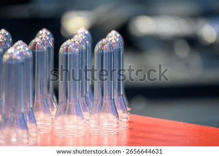 Close up scene of group of preform shape of PET bottle products. The raw material for plastic bottle manufacturing process.