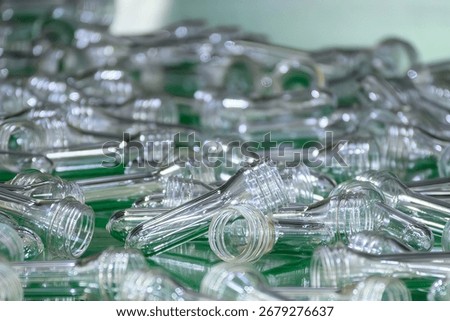 Close up scene of group of preform shape of PET bottle products. The raw material for plastic bottle manufacturing process.