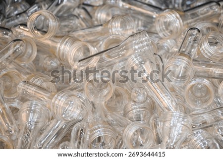 Close up scene of group of preform shape of PET bottle products. The raw material for plastic bottle manufacturing process.