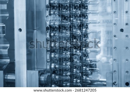 Close up scene of injection process group of preform shape of PET bottle products in the blue scene. The preform shape for PET bottles manufacturing concepts.