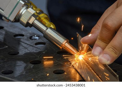 Close up scene the laser welding process by hand held laser welding machine. The high technology welding process by laser welding machine. - Powered by Shutterstock