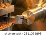 Close up scene  the lathe machine finish cut the brass shaft parts. The metalworking process by turning machine.