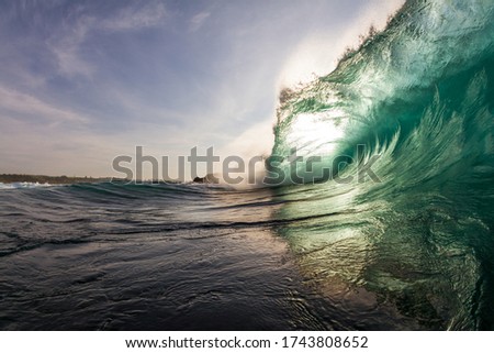 close up scene of a massive wave breaking on a reef while swimming