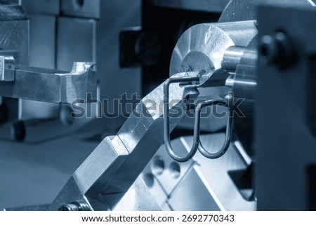 Close up scene operation of the coil spring making machine. The mechanical parts manufacturing concept.