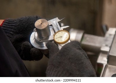 Close Up Scene The Operator Measuring Outside Diameter Metal Shaft Parts By Dial Vernier Caliper. The Quality Control On Turning Machine. 