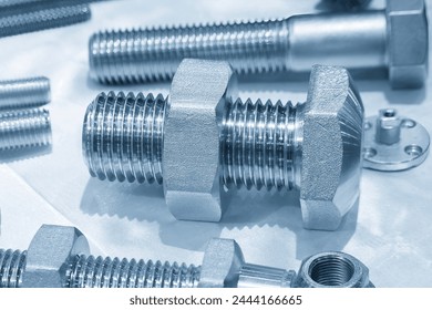 Close up scene the set of nut and bolts in the light blue scene. The manufacturing concept of construction material.  - Powered by Shutterstock