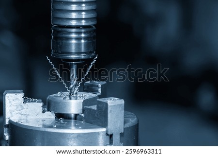 Close up scene the tapping process on CNC milling machine with tapping holder in the light blue scene. The thread cutting concept on machining center.
