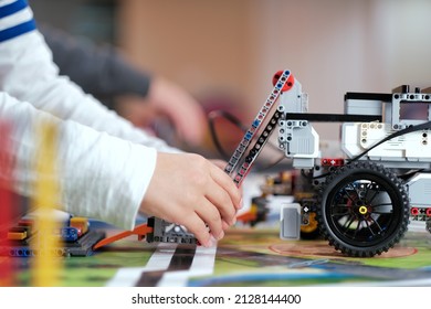 Close Up Of School Students Designing And Testing STEM Robot Vehicle Project Model In Robotics Class For The Competition. Science, Technology, Innovation, Creativity, Education STEM.