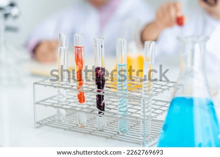 close up scientific test tube placed on the table in the science room. The colors are mixed in the test tube. doing chemistry experiments in elementary school