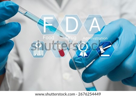Close up of scientist with blue gloves using pipette and test tube in laboratory with FDA approval icons, representing food and drug administration, safety standards, clinical testing, and regulation.