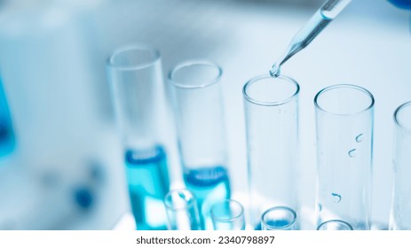 Close up of scientist is dropping blue liquid substance in science test tube in laboratory. Concept of science, biochemistry, chemical, diagnosis, biotechnology. Substance study analyzing experiment - Powered by Shutterstock