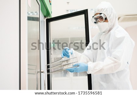 Close up scientist hand opening storage reagent container for laboratory analysis.Scientist hand holding reagent tube during prepare specimen for auto machine analysis.Laboratory medical analysis.