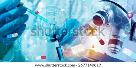 Close up of scientist hand using pipette with blue liquid in test tube under microscope, combined digital graphic of capsules and molecules, symbolizing pharmaceutical innovation, medicine and science