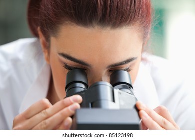 Close Up Of A Scientist Looking Into A Microscope In A Laboratory