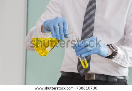 Close Up of Scientist Studying oil Solution in Test Tube