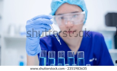Close up scientist use dropper with blue liquid dripping with precision, substance holds the key to discovery in biology, medicine, and biotechnology, research and analysis through experiment analysis