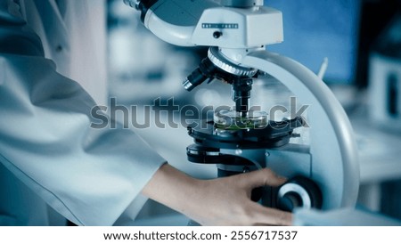 Close Up of a Scientist Using Microscope to Analyze Biological Specimens. Anonymous Person Adding Liquid Solution to Multiple Petri Dishes. Laboratory Work for Advancing Medical Knowledge
