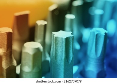 Close up screwdriver with five edges. A set of small screwdrivers. A nozzle on a small screwdriver. Horizontal image.