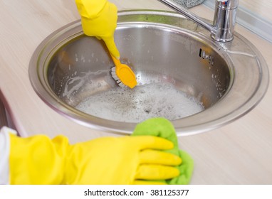 Close Up Of Scrubbing Brush In The Kitchen Sink. Kitchen Cleaning Concept