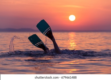 Close Up Of Scuba Diver Feet With Snorkel Fins Start Diving At Sunset