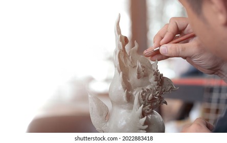 Close up of Sculptor artist creating The statue with clay.  by using specific sculptural tools for drawing patterns and shaping.  - Powered by Shutterstock