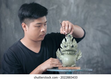 Close up of Sculptor artist creating The statue with clay.  by using specific sculptural tools for drawing patterns and shaping.  - Powered by Shutterstock