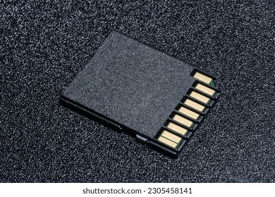 Close up of an SD Card on black textured background