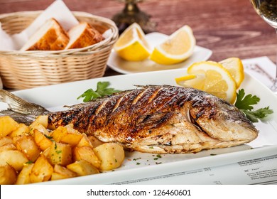 Close up of sea bream fish with potato - Powered by Shutterstock