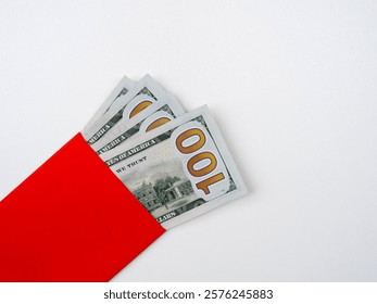 Close up a section of 100 numbers on one hundred dollars bill banknote cash, money fan, in red envelope, isolated on white background, top view.