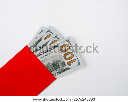 Close up a section of 100 numbers on one hundred dollars bill banknote cash, money fan, in red envelope, isolated on white background, top view.
