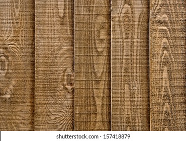 A Close Up Section Of Wooden Garden Fencing With Vertical, Overlapped Panels.