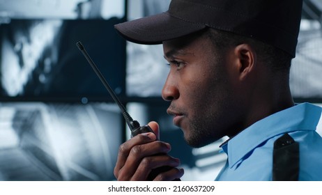 Close Up Of Security Guard Look At Monitor And Report On Walkie Talkie. Security Office 