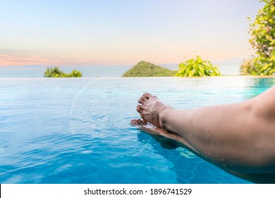 Close up and select legs.  Women lifestyle relaxing and happy in luxury infinity pool outdoor, summer time at resort in the hotel. Summer holiday and Vacations concept. soft focus select feet