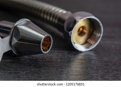 Close Up With Selective Focus Of A Metal Bidet / Hose