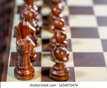 Close up and selective focus on black chess pieces on an electronic chess board