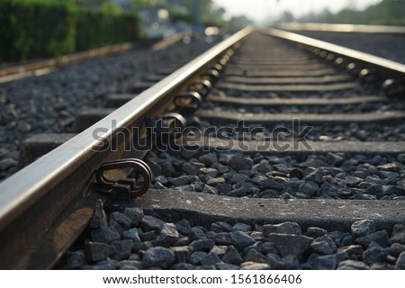 Close up and selective focus photo of railway track or railroad or rel kereta api with morning sunlight.