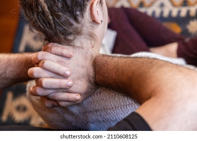 Close up and selective focus view on the hands of a Shiatsu practitioner at work on the upper back and neck of caucasian woman. Copy space to right.