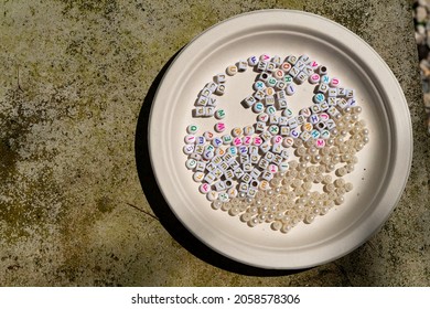 Close up and selective of multiple color of small plastic alphabet letter block in the plate
