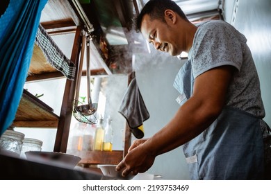 close up of a seller prepares the spices the bowl while preparing the dish on the cart - Powered by Shutterstock