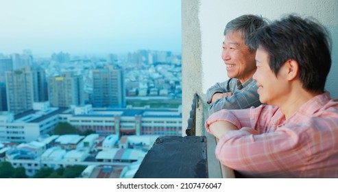 Close Up Of Senior Asian Couple Looking Outside From Home