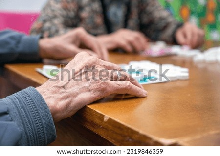 Close up of a senior group playing bingo at Nursing home. leisure game, support, assisted living, and retirement. High quality photo