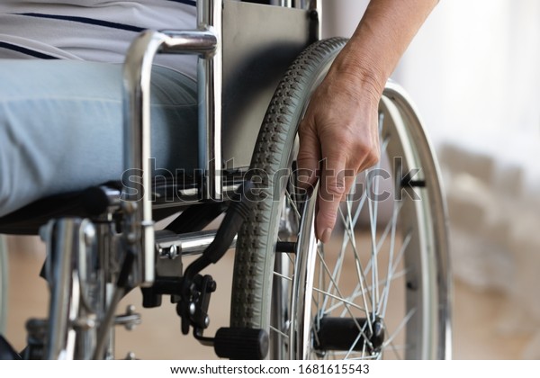 Close\
up of senior handicapped woman sit in wheelchair taken care of in\
hospital or home, mature disabled old lady grandmother in invalid\
carriage or wheel chair, elderly disability\
concept
