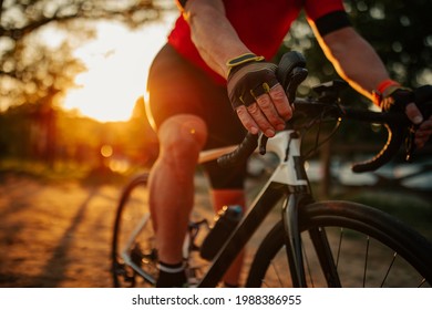 Close Up Of Senior Man Riding Bike Through Forest