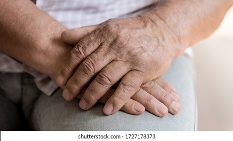 Close Up Of Senior Man Sit Hold Hands Feeling Lonely Or Abandoned In Retirement House, Old Male Patient Thinking Pondering Of Life Problems, Miss Good Old Days, Elderly Solitude, Loneliness Concept