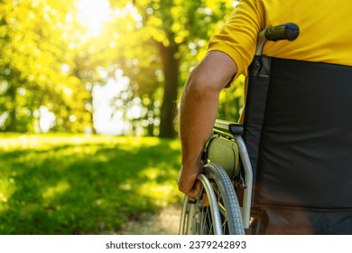 Close up of senior man sit in wheelchair during walk in park with copyspace, mature disabled old man grandfather in  carriage or wheel chair, elderly disability concept image - Powered by Shutterstock