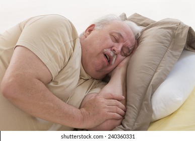 Close Up Of Senior Man Sleeping And Snoring In Bed
