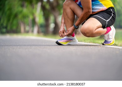 Close Up Of Senior Man Tying Running Shoes.